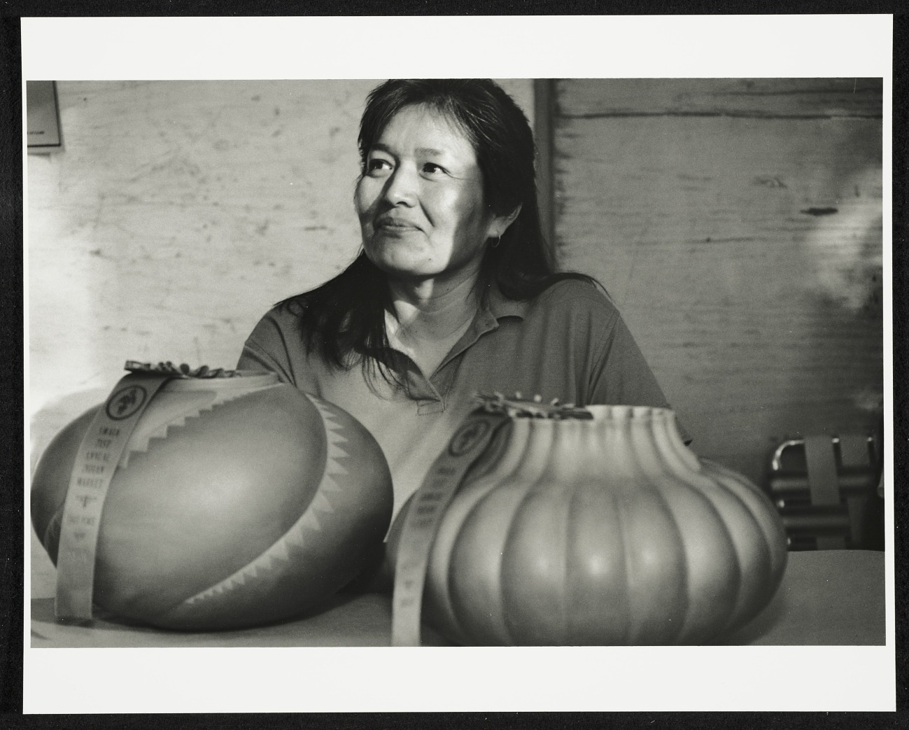 The Navajo artist with two of her pots