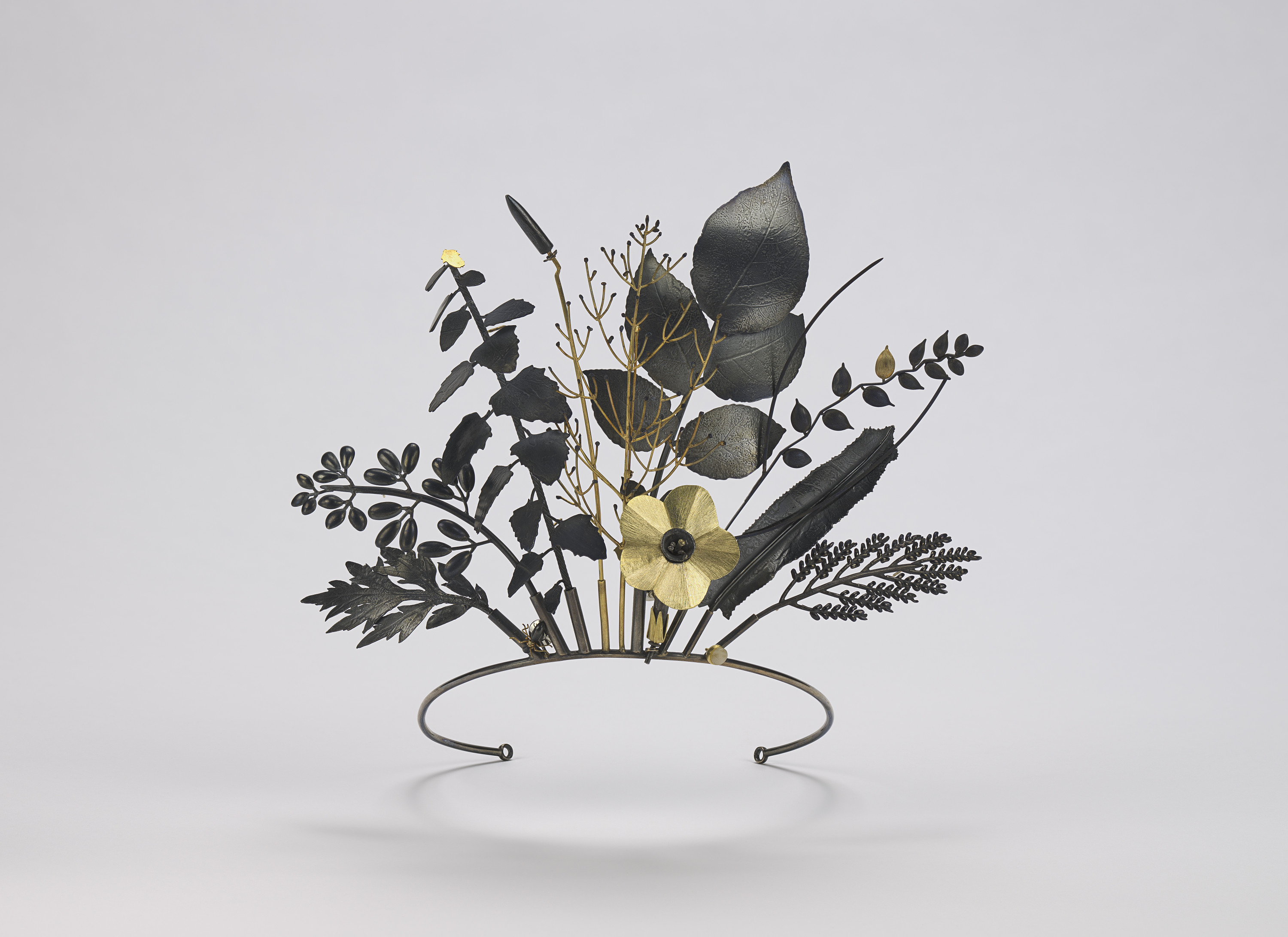 Floral-shaped tiara made of gold, silver, and quartz.