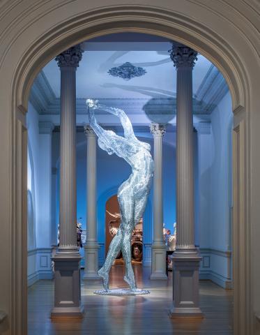 An image of a sculpture piece of a woman stretching her arms out inside the Renwick Gallery.