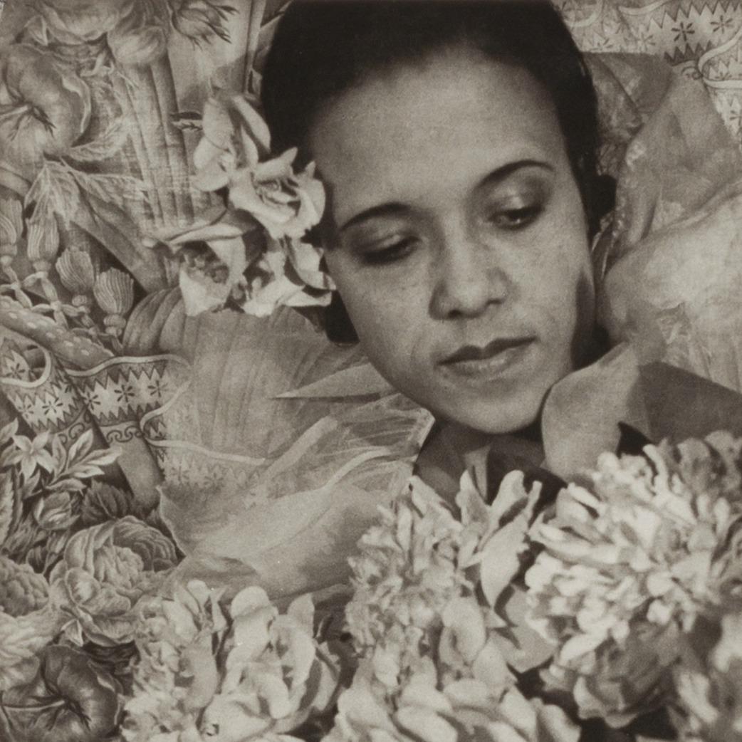 Black and White photo of woman surrounded by flowers.