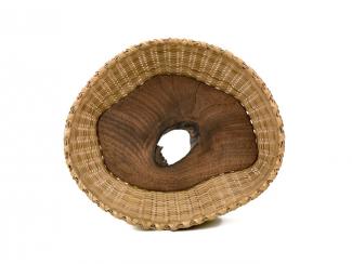 A basket with a white oak and walnut center. 