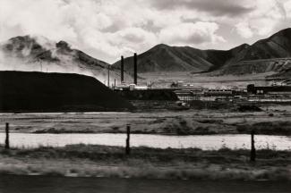 A photograph of a Utah landscape with mountains by automobile.