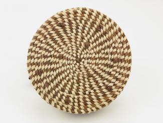 A basket that's circular with a pattern woven into it. 
