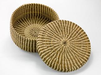 A basket with a circular base with straight sides and a lid.