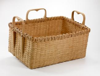 A basket that is rectangular with three heart shaped handles.