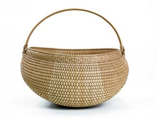 A basket with a half circle shape with a circle handle.