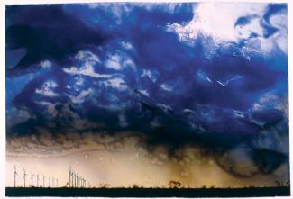 Rockman's oil painting of a rain storm over windmills.