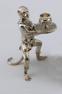 An image of Vitali's silver candlestick holder in the shape of a monkey.