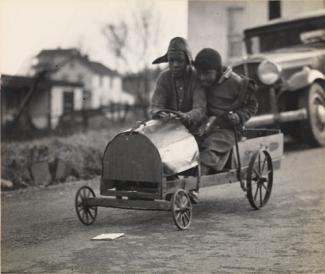 McNeill's gelatin silver print of two boys in a homemade racer.