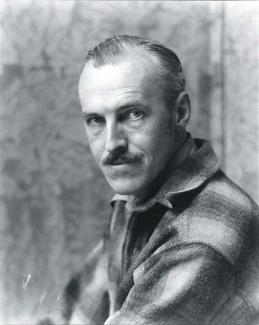 A photograph of man in a plaid shirt.