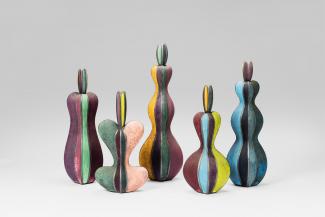 Five colorful ceramic bottles.