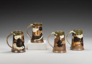 Four ceramic mugs.