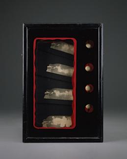 A box with four artifacts inside.