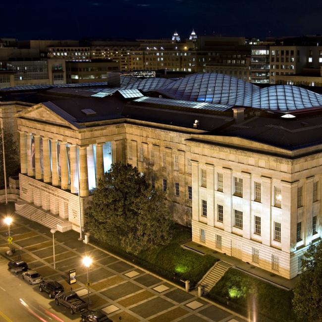 This is a night image of the exterior of the Smithsonian American Art Museum.