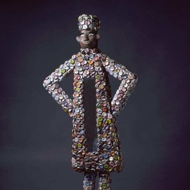 A photograph of an artwork made from bottle caps
