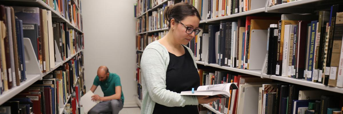 Hero - Research library books Two researchers in library stacks