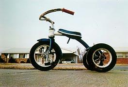 A photograph of a tricycle at a low angle
