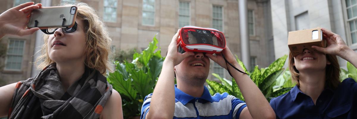 An image of three people playing the wonder360 app with different VR attachments to their smart phones.