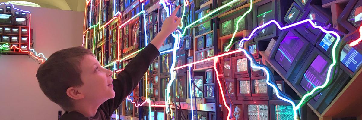 Student in front of Nam June Paik's Electronic Superhighway