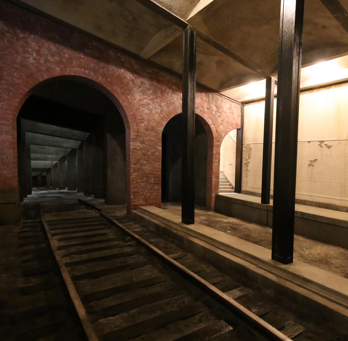 A photograph of Rick Araluce's Final Stop structure depicting a train station platform with tracks and tunnels.