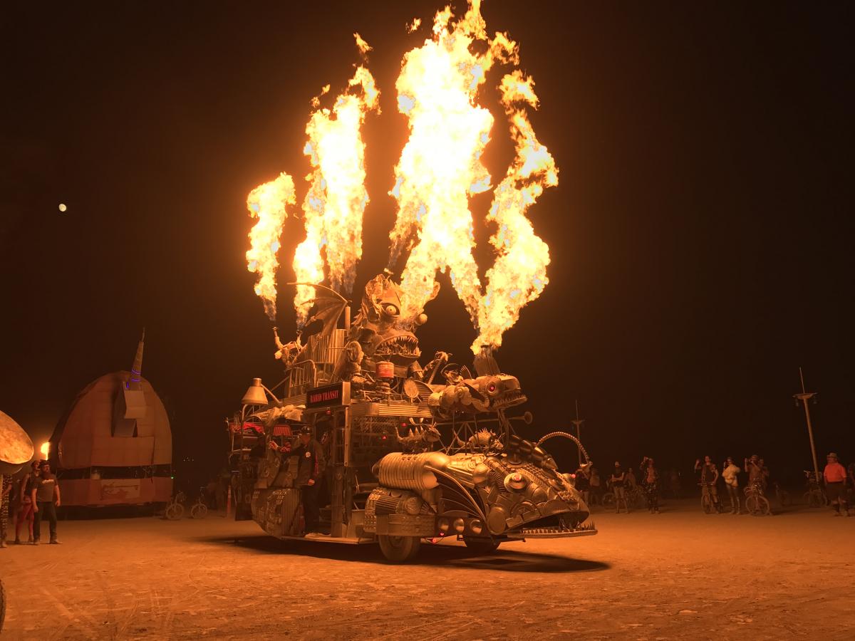 A picture of Burning Man, 2017, with an art object shooting flames.