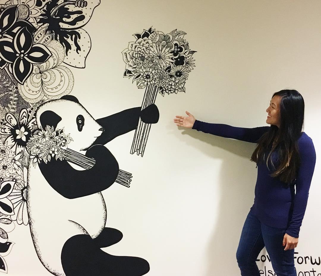 woman posing with panda wall mural