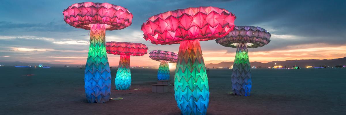 A photo of Shrumen Lumen, a faceted mushroom sculpture piece, installed in the desert at Burning Man 2017.