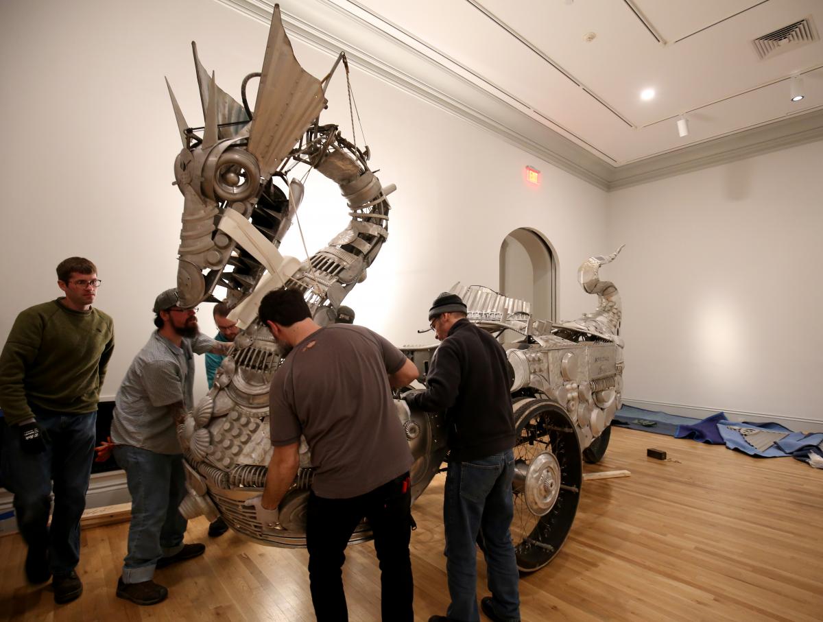 The museum team and artist working to assemble the dragon