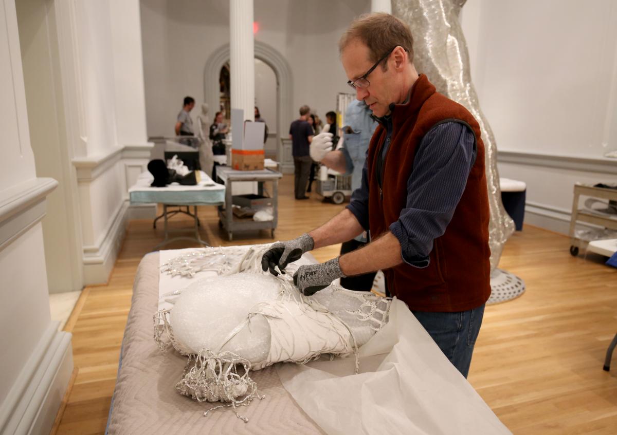 This is a behind the scene image of a costume being unpacked at the Renwick Gallery.