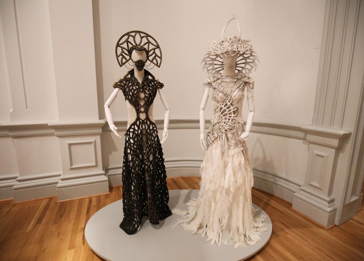A photograph of two costumes for Burning Man at the Renwick Gallery.