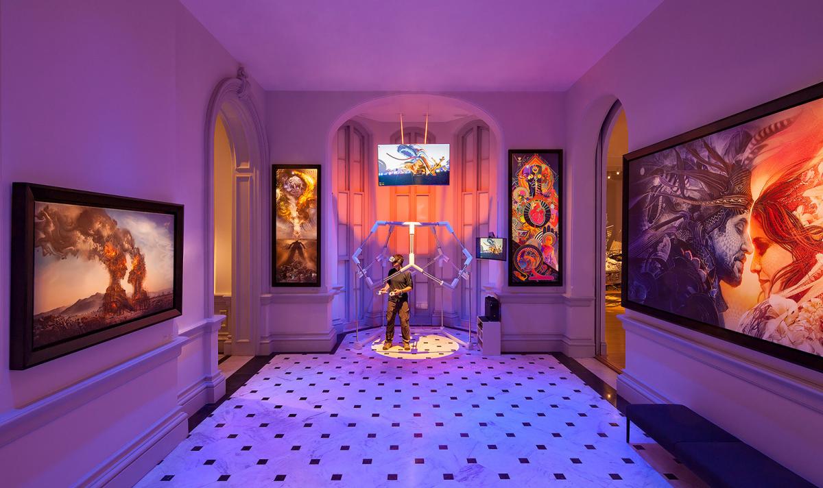 A picture of a gallery view with paintings on the wall and a VR station in the middle.