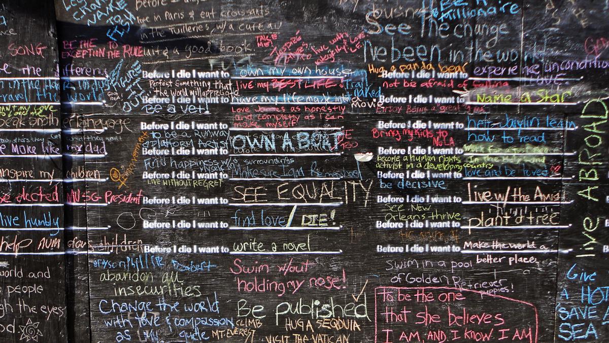 This is a detail of a chalkboard with writing on it by Candy Chang.