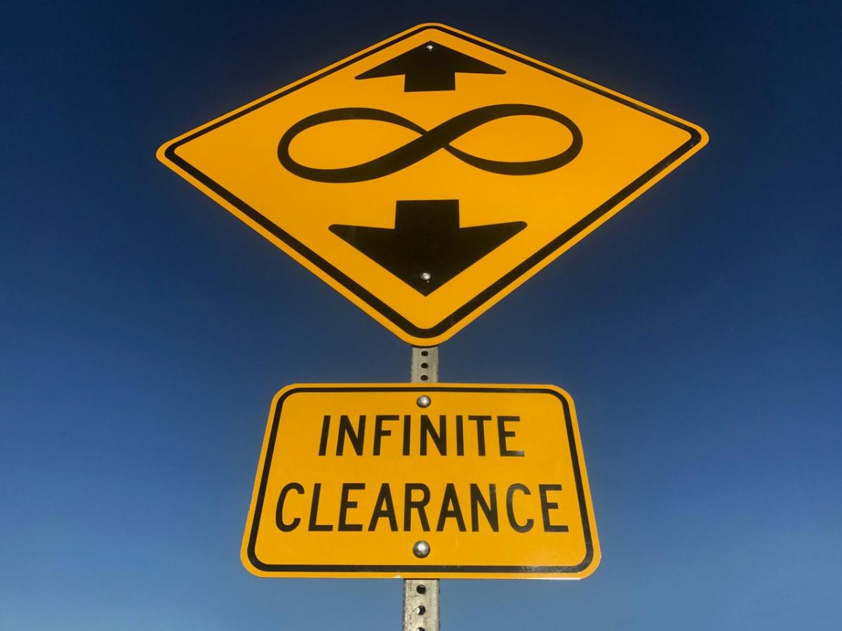A picture of a yield sign with an infinity symbol on it. 