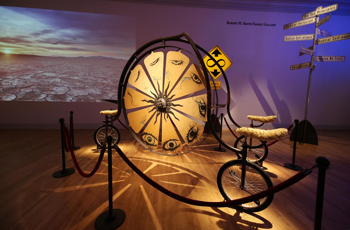 An image of a three man bike with a big wheel in the center that you can spin.