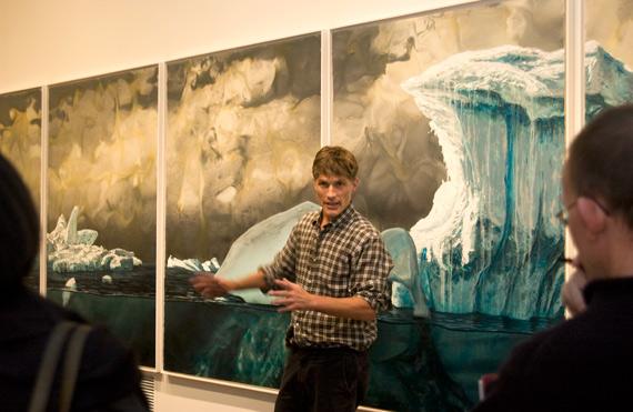 Alexis Rockman speaking in front of his painting South