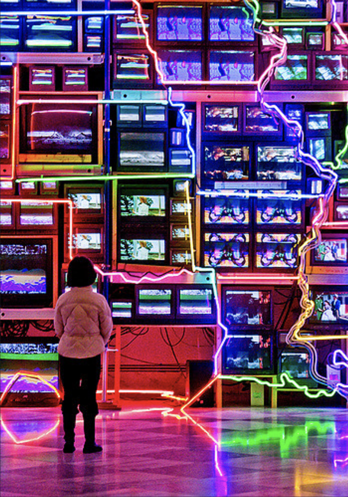 A visitor to American Art looks at Nam June Paik's Electronic Superhighway: Continental U.S., Alaska, Hawaii.