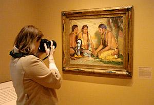 person taking a photo of an artwork
