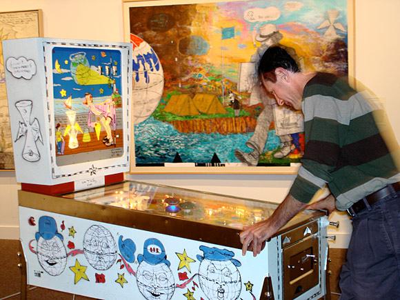A museum visitor plays William T. Wiley's Punball: Only One Earth