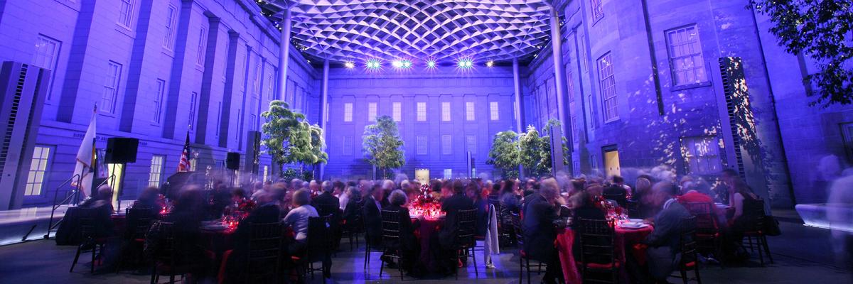 This is an image taken inside the Kogod Courtyard at the Smithsonian American Art Museum at night during an event.