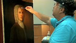 Conservator working on a painting.