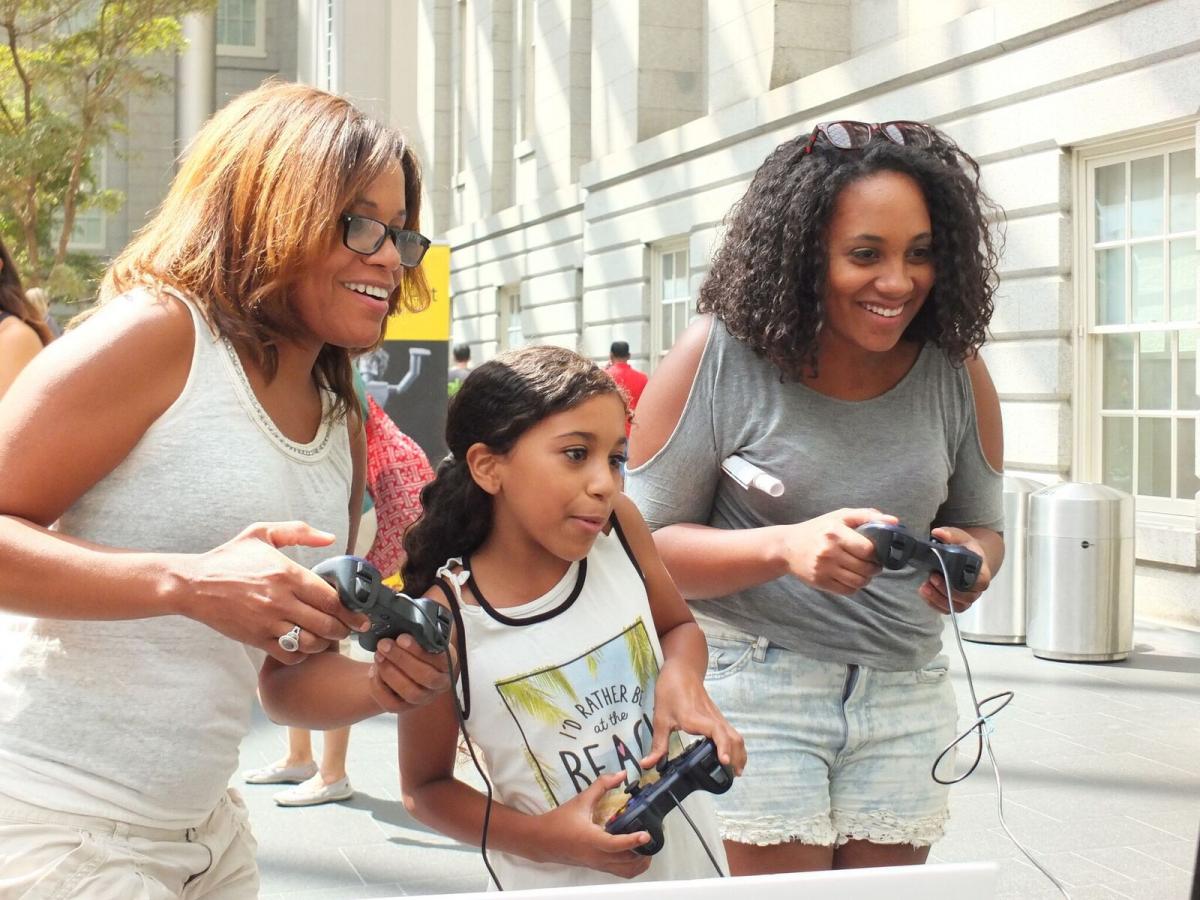 Playing video games at SAAM Arcade.
