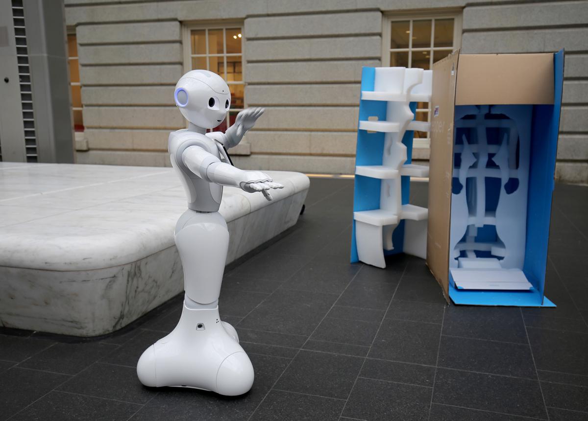 A photograph of Pepper the Smithsonian Robot dancing inside the Smithsonian American Art Museum.