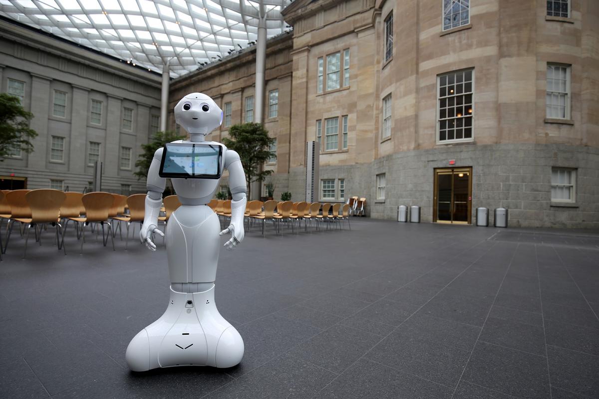 A photograph of Pepper the Smithsonian Robot dancing inside the Smithsonian American Art Museum.