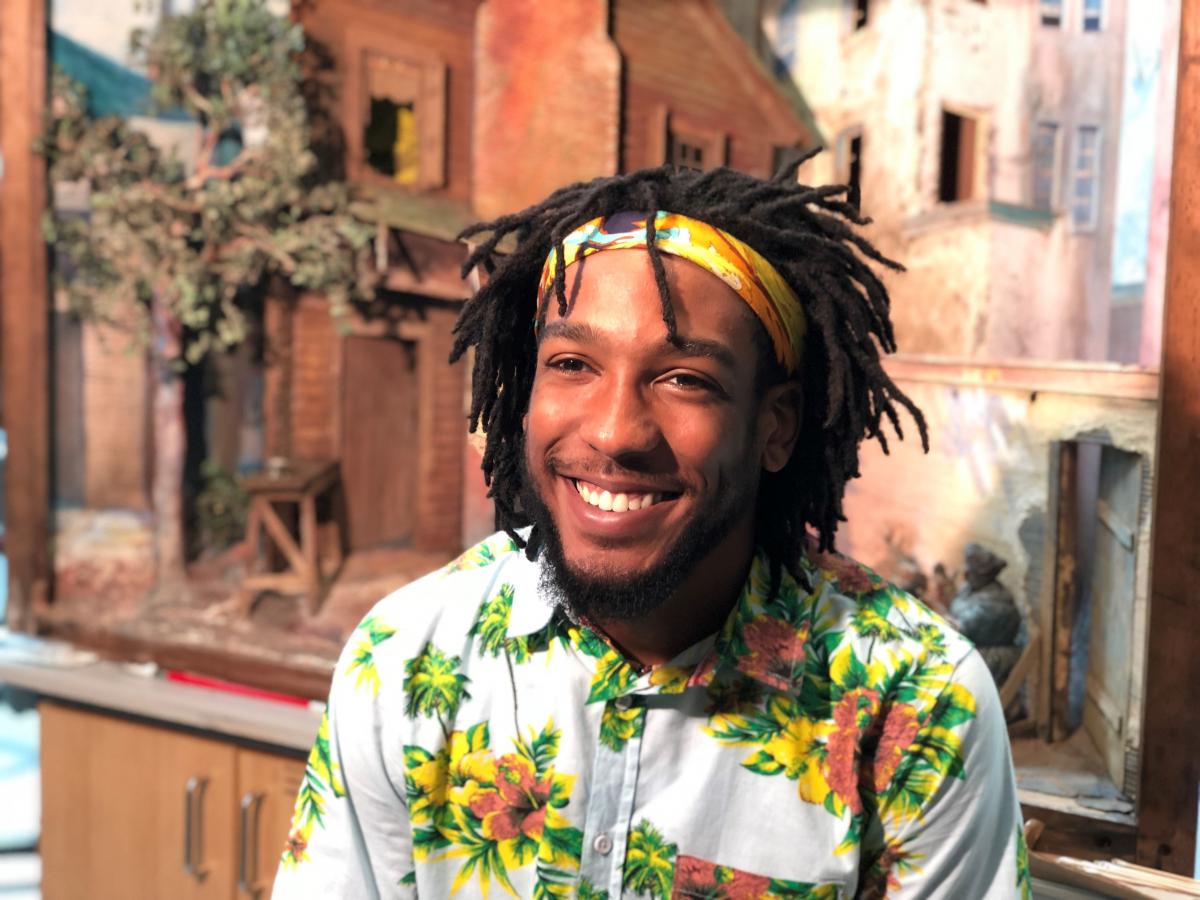 Matthew Fields at the Lunder Foundation Center in front of the diorama Reconstruction After the War