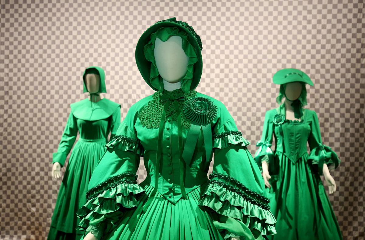 A photograph of three green chroma-key dresses. 