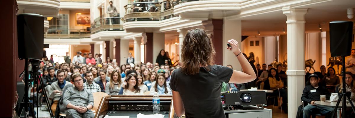 An image of a crowd of people listening to a person talking in the Luce Foundation Center.