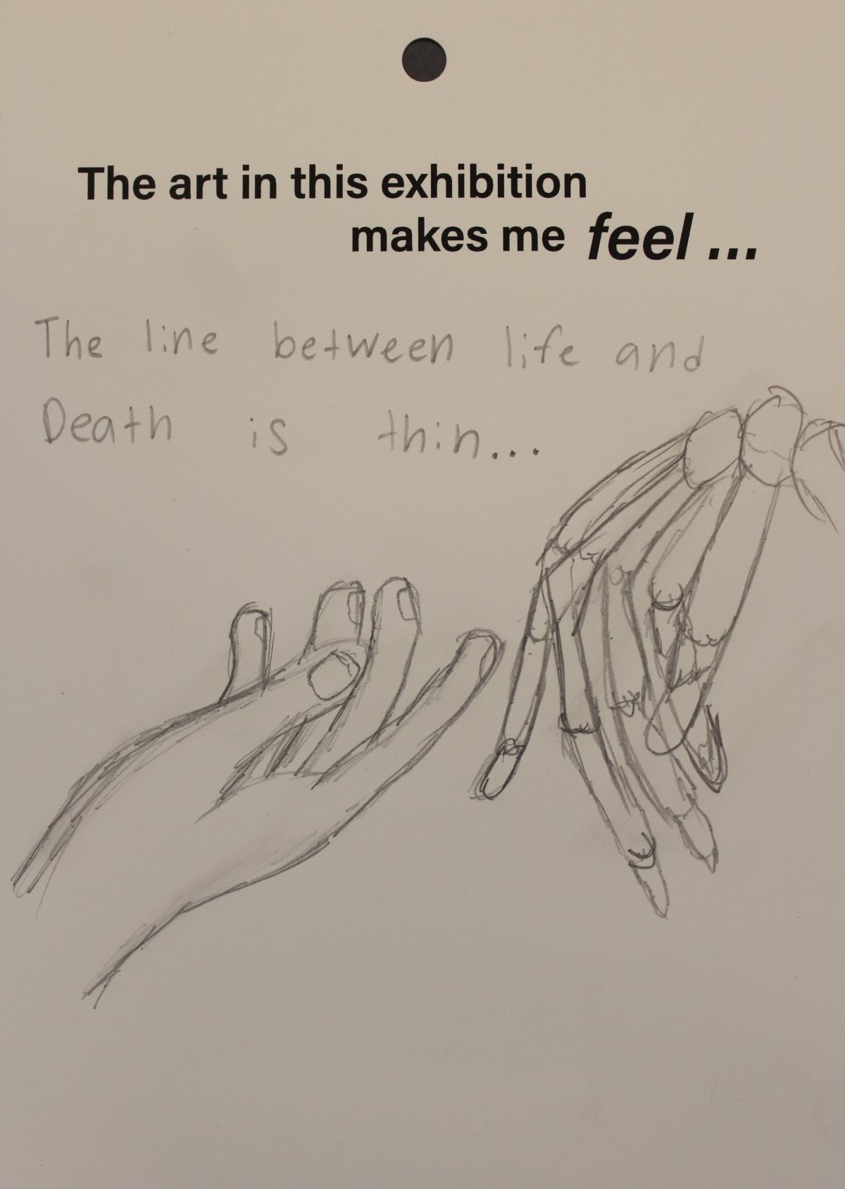 A visitor draws a hand and a skeletal hand