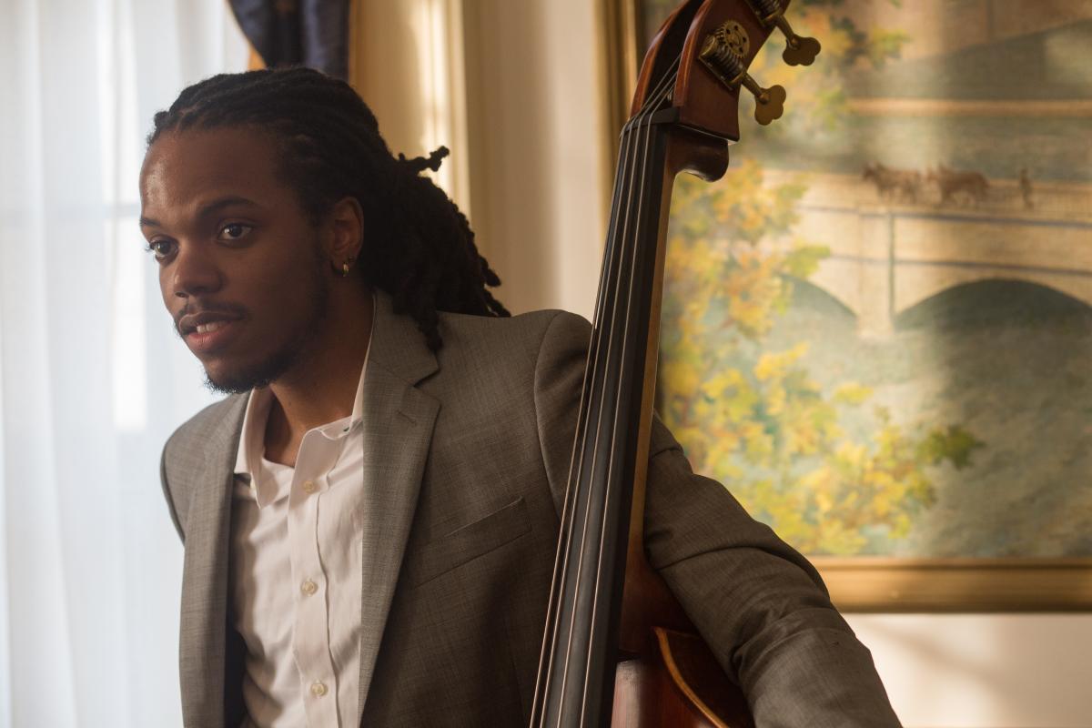 Musician Tyrone Allen standing with his bass.