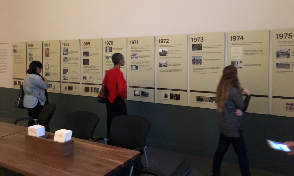 Visitors encounter the timeline in the exhibition, Artists Respond: American Art and the Vietnam War, 1965-1975
