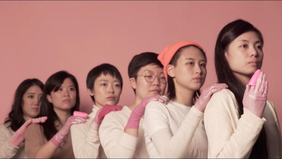 An image of six women each with a hand filled with pink slime